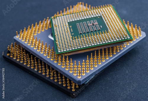Stack of different CPU Processor Chips on dark background close up