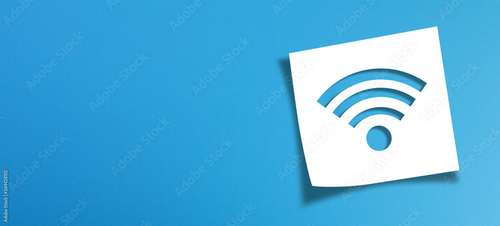 Note paper and wifi sign with copy space on panoramic blue background Note paper and wifi sign with copy space on panoramic blue background
