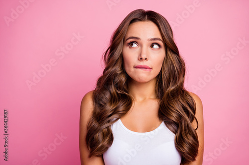 Closeup photo of funny pretty wavy lady wondered look up empty space read sale shopping banner biting lips dreamy wear white casual tank-top isolated pink color background
