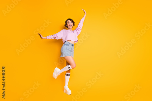 Full length photo of enthusiastic content girl enjoy spring holiday free time raise hands scream rejoice wear good look pullover footwear isolated over bright color background