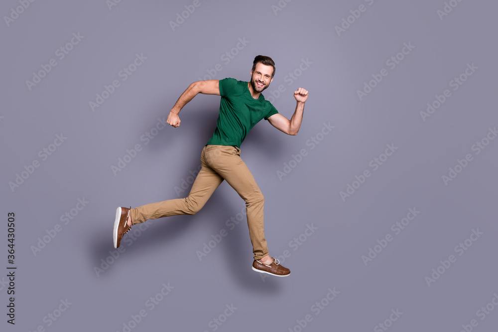 Full length profile side photo of excited guy jump run after spring season time discount wear good look clothes footwear isolated over gray color background