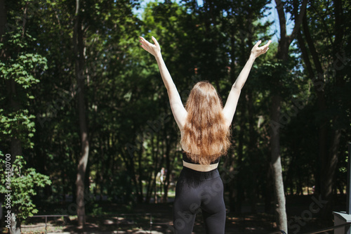 Achievement and life goals. Happy woman celebrating rising hands after training. Female sportsman expressing positivity and success. Freedom, confidence, motivation