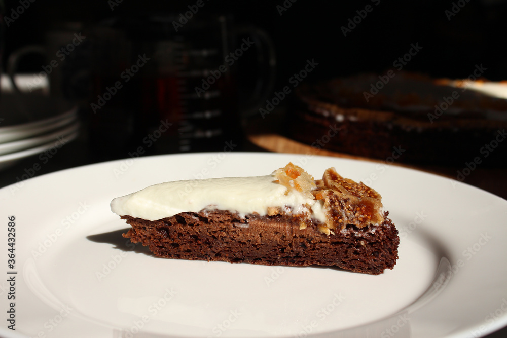 A piece of homemade delicious brownie with cream and dried fruit dates and cantaloupe A piece of homemade delicious brownie with cream and dried fruit dates and cantaloupe