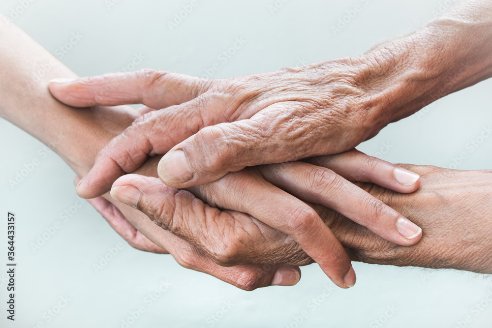 Hands of young adults and older women on a light background Hands of young adults and older women on a light background