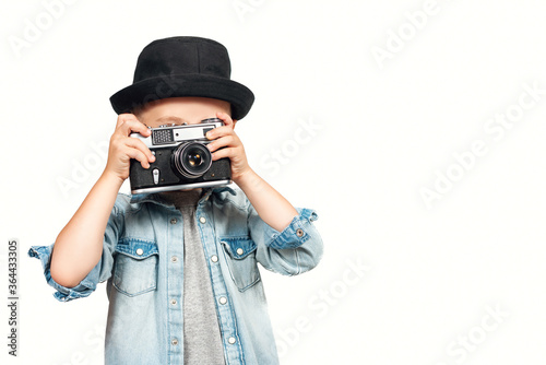 Photographer kid taking a photo with vintage retro camera