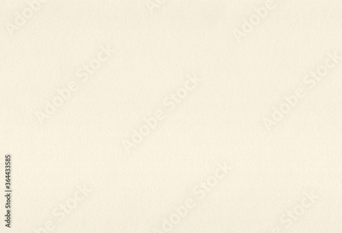 Sheet of textured pale yellow coloured creative paper background. Extra large highly detailed image. photo