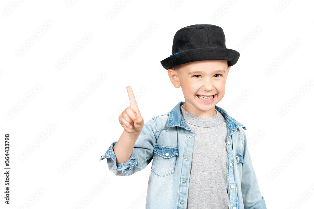 Portrait of stylish amazed kid pointing to empty place on background Portrait of stylish amazed kid pointing to empty place on background