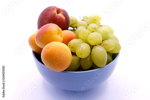 Grape bunch  peaches and apricot close-up on a white background