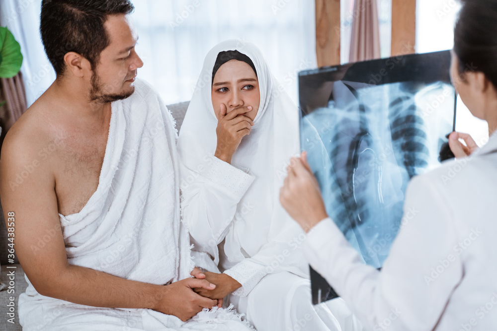 Fototapeta premium sad muslim woman and husband being cancel to travel for hajj