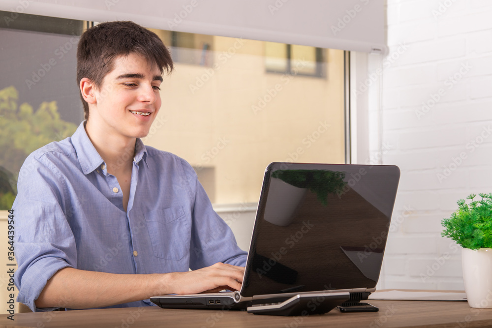 teenage student with computer at desk at home or college teenage student with computer at desk at home or college