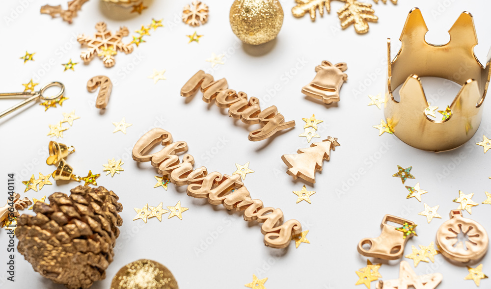 merry Christmas gold shiny text with luxury xmas decoration items on white table.happy new year holiday concept merry Christmas gold shiny text with luxury xmas decoration items on white table.happy new year holiday concept