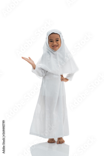 beautiful muslim child with hijab presenting copyspace photo