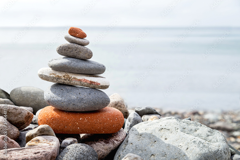 Fototapeta premium Stack of stones on the coast (beach) of the sea. Natural background.
