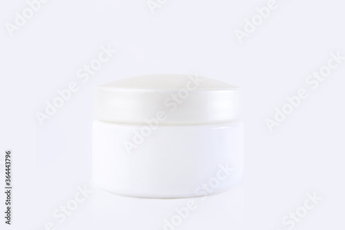 White jar with cream on a white background. Stylish look of the product, mock up.
