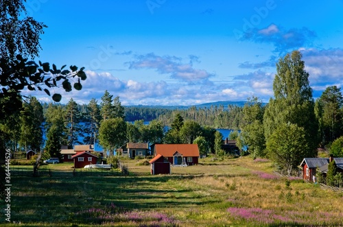 The small village of Dala Floda in rural Dalarna ,surrounded by water and forests on a sunny summer morning. photo