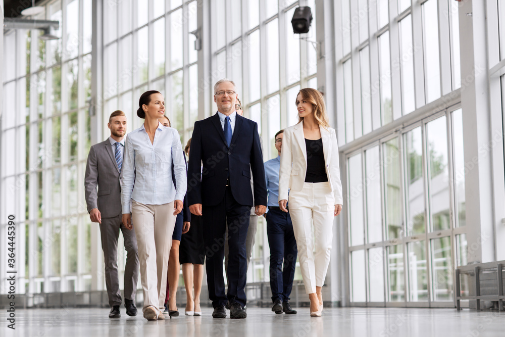 people, work and corporate concept - happy business team walking along office building people, work and corporate concept - happy business team walking along office building