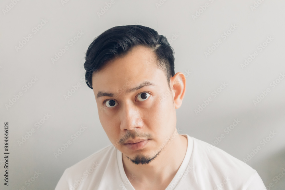 Asian man is checking out his new haircut after covid-19 quarantine. Asian man is checking out his new haircut after covid-19 quarantine.