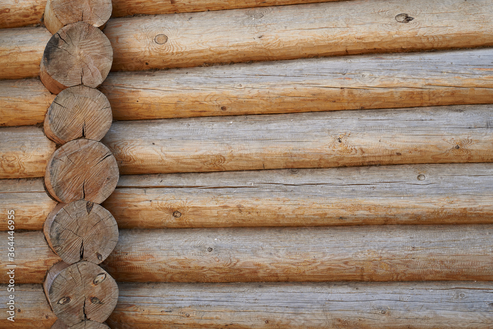 A wall made of natural wood of different sizes and shapes, Log house or barn, textured horizontal walls A wall made of natural wood of different sizes and shapes, Log house or barn, textured horizontal walls