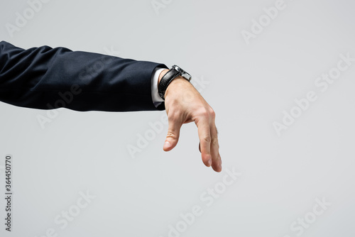 cropped view of businessman manipulating with hand isolated on grey