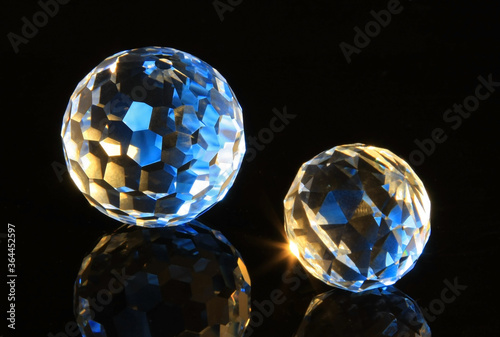 Faceted glass sphere on a black reflective surface