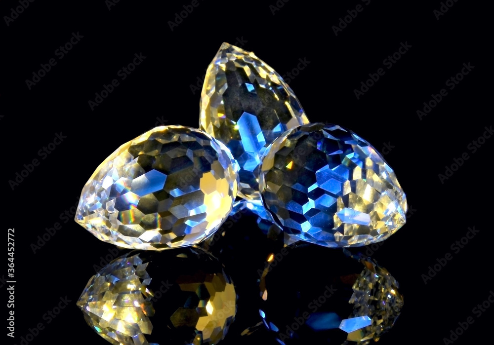 Large faceted crystals on a black reflective surface Large faceted crystals on a black reflective surface
