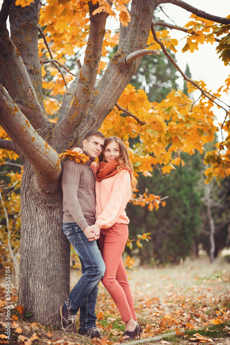Young couple in love outdoor.Stunning sensual outdoor portrait of young stylish fashion couple posing in park in autumn