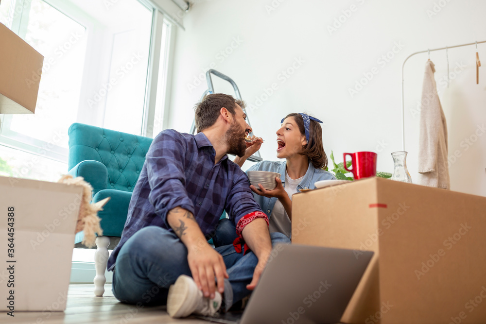 Couple having breakfast while moving in new home Couple having breakfast while moving in new home