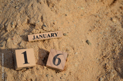 January 16, Number cube with Sand pile for a background.