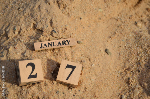 January 27, Number cube with Sand pile for a background.