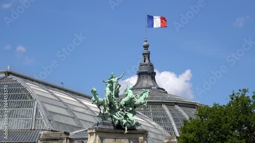 French flag waving on top of Grand Palais with bronze quadriga statue 