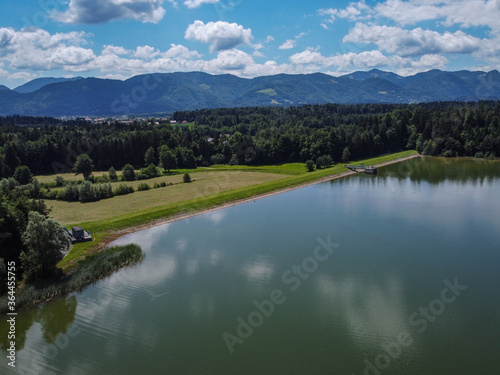 Panorama of Zovnesko jezero or Zovnek lake in Slovenia, on a hot summer day. Visible man made dam in the background used for irrigation. © Anze
