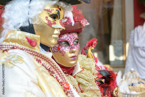 Two disguised people in the Venice carnival found in the streets of Burano, a little island in Venice lagoon. Their camouflage recall the old traditional Venetian fashion