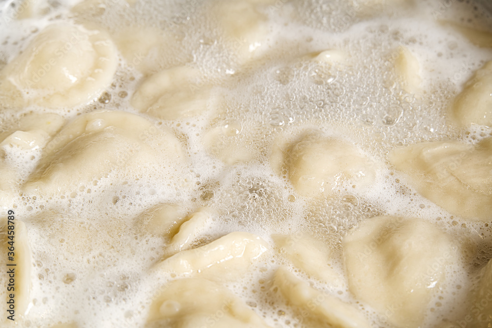 cooking dumplings in a pan with water, Meat in dough rolls. Top view. cooking dumplings in a pan with water, Meat in dough rolls. Top view.