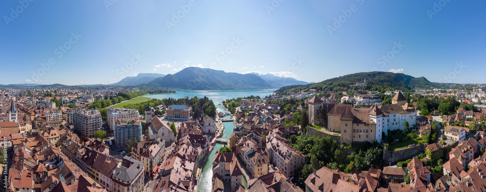 Annecy city center panoramic aerial view with the old town, castle, Thiou river and mountains surrounding the lake, beautiful summer vacation tourism destination in France, Europe - obrazy, fototapety, plakaty 