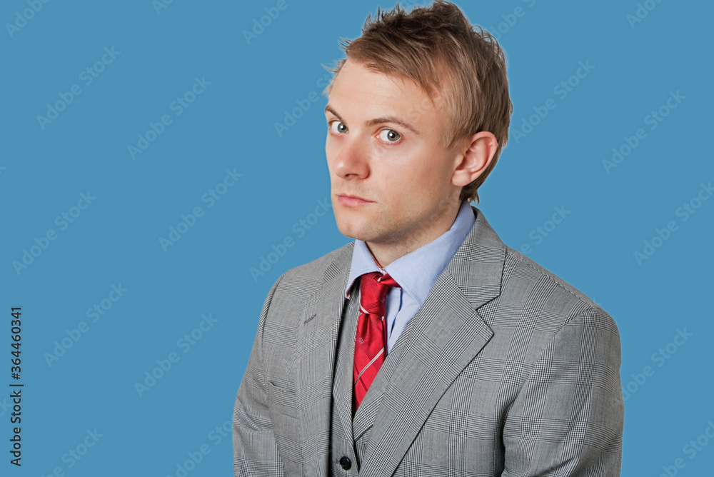 Portrait of angry young businessman wearing grey suit Portrait of angry young businessman wearing grey suit