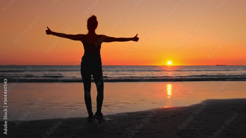 Woman in fitness clothes on the ocean shore, enjoys her successes. Woman in fitness clothes on the ocean shore, enjoys her successes.