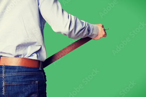 Man tightening his brown belt