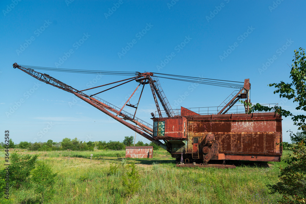 Old rusted walking excavator near abandoned coal mine Old rusted walking excavator near abandoned coal mine