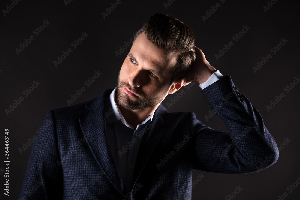Close-up portrait of his he nice attractive content well-groomed guy agent broker employer partner leader touching hairdo corporate trend isolated on dark black color background