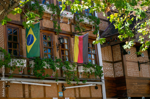 Fototapeta Naklejka Na Ścianę i Meble -  Campos do Jordão, São Paulo, Brazil - May 26, 2020: flags of Brazil and Germany in a commercial establishment in the city's tourist square.