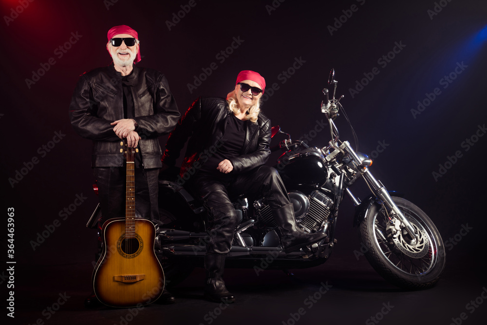 Obraz premium Full length photo of old two cool bikers man lady sit chopper rock festival play guitar famous popular metal band meeting wear trendy rocker leather outfit isolated black color background