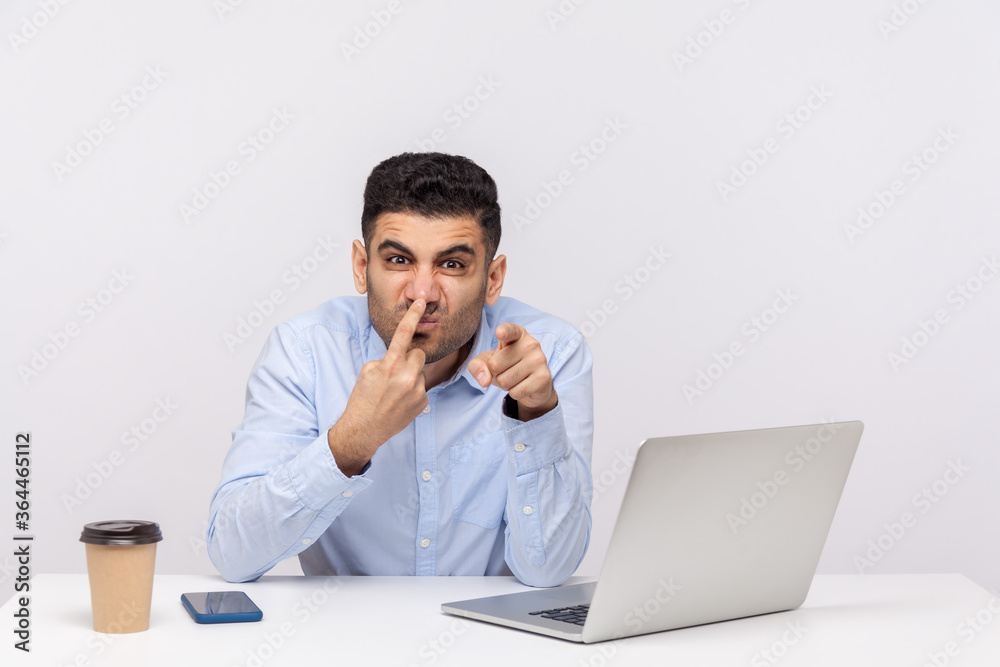 You are telling lie! Angry businessman sitting office workplace with laptop, touching nose showing liar gesture, suspecting falsehood. Body language, indoor studio shot isolated on white background You are telling lie! Angry businessman sitting office workplace with laptop, touching nose showing liar gesture, suspecting falsehood. Body language, indoor studio shot isolated on white background