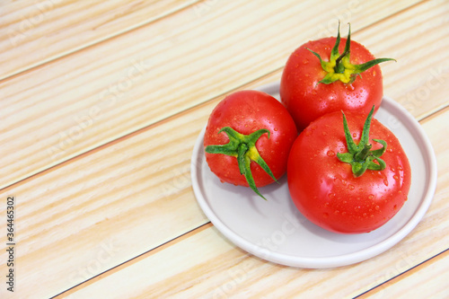 natural red tomato on a decorative plate