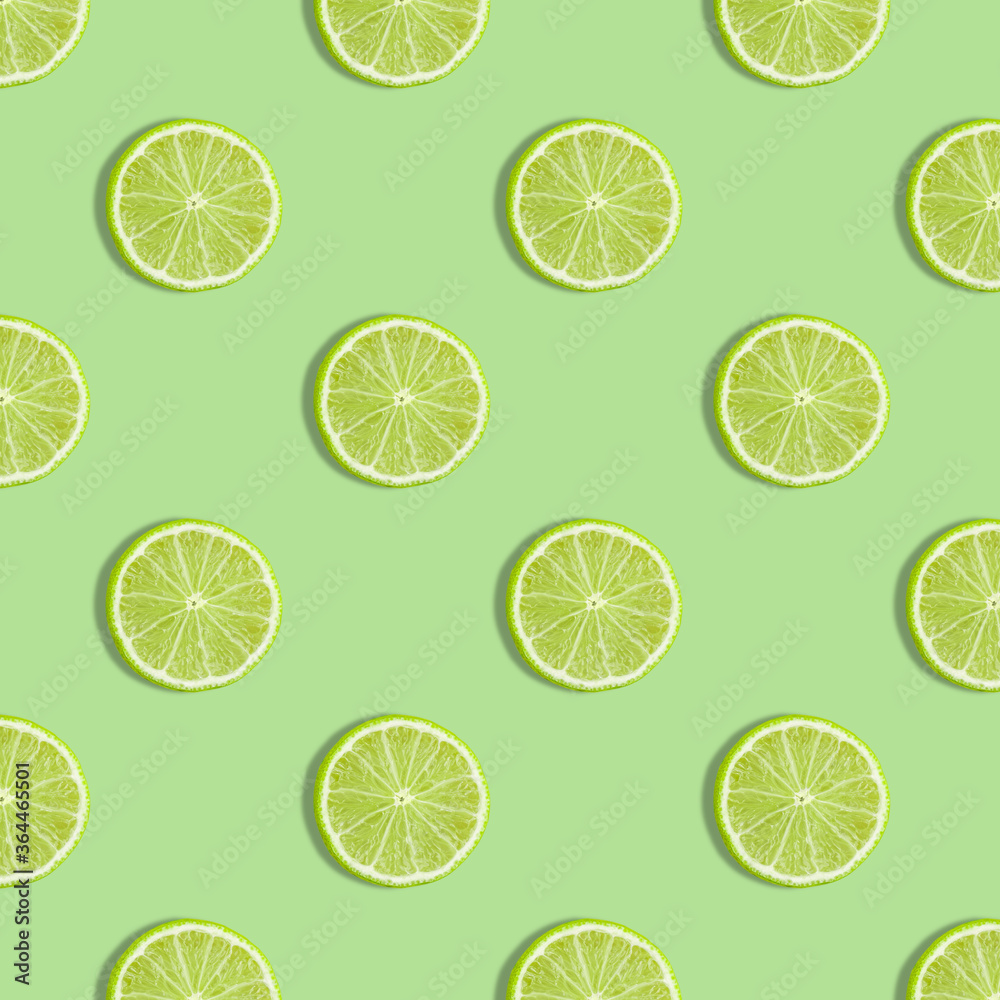 Colorful fruit seamless pattern of fresh lime slices on green background. Trendy sunlight Summer pattern. Minimal summer concept. flat lay food texture