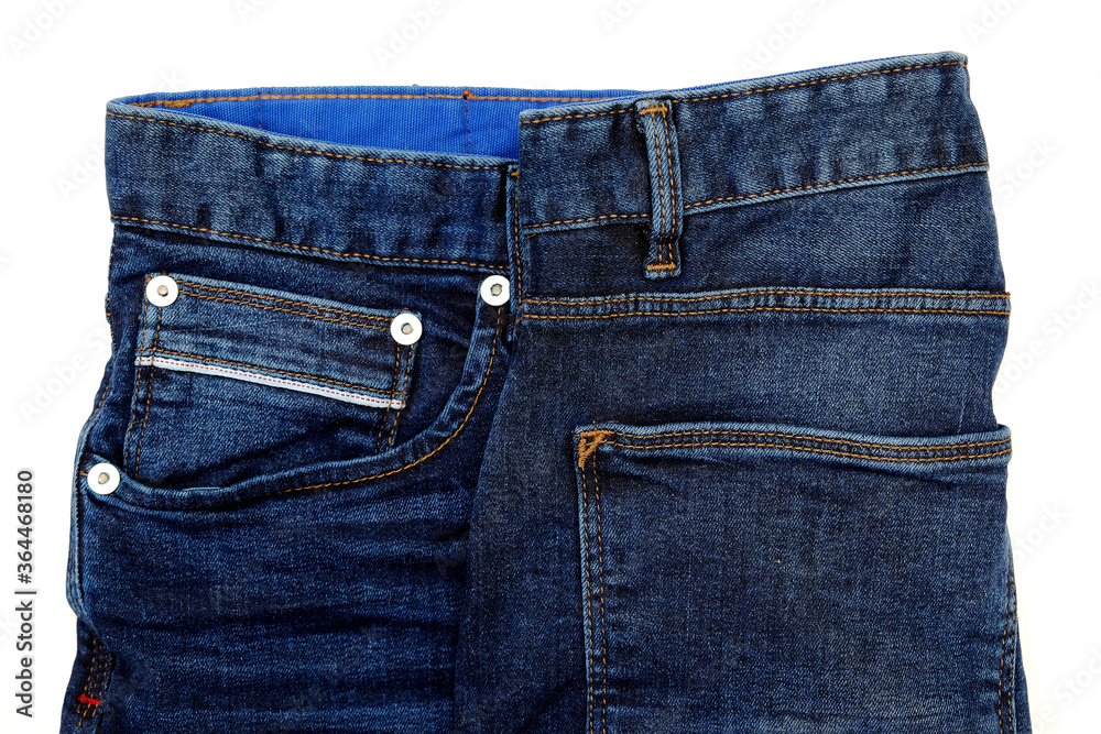 A pair of blue jeans isolated on a white background.Horizontal close up detail shot.