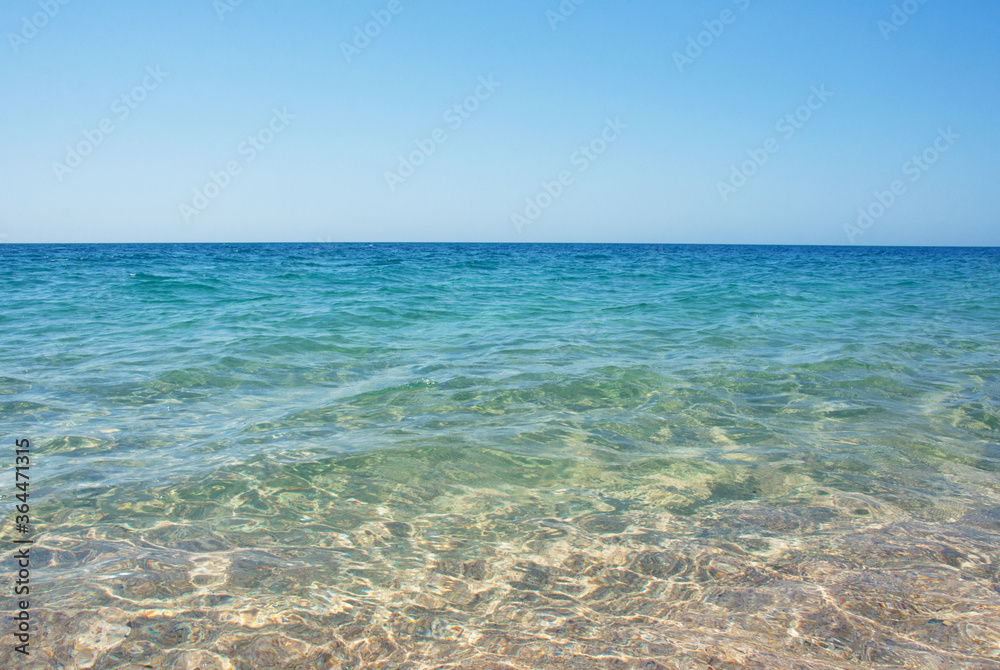 Transparent clear sea with a sandy shore. The shore of the Black Sea. Holidays on the shore