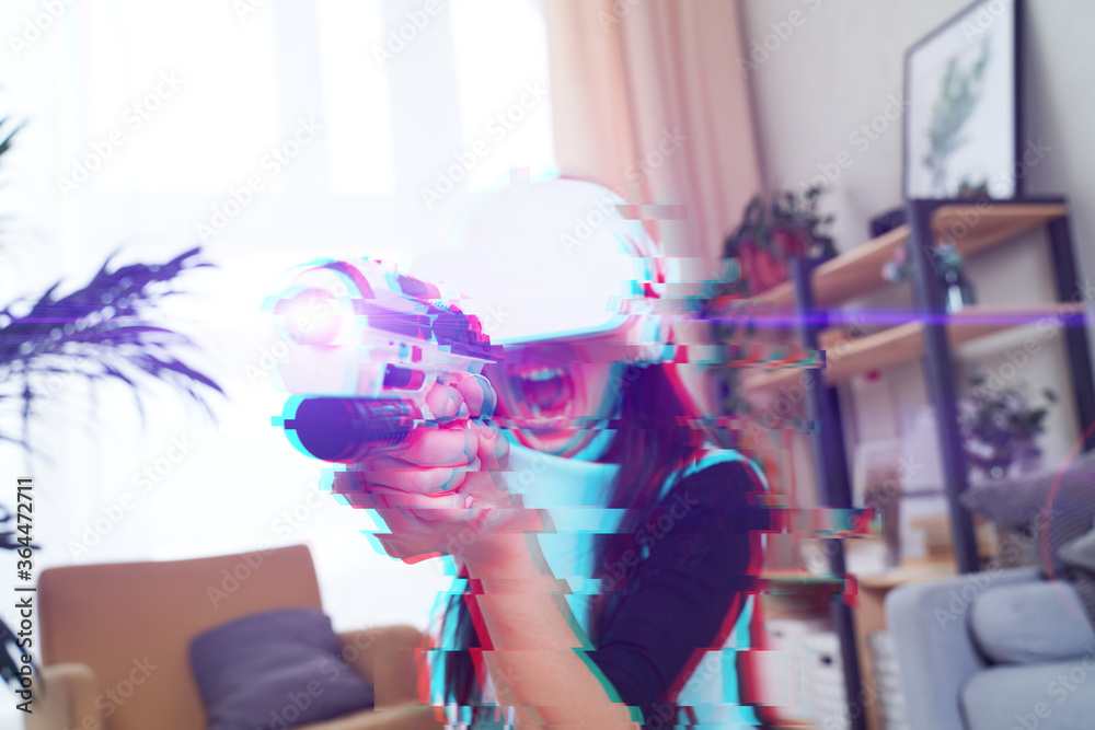 Woman with virtual reality headset is playing game. Image with glitch effect.