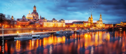 Fantastic, evening cityscape of Dresden, Old Historical Town with Reflection in Elbe River in the foreground. Panoramic image of Dresden, Germany during sunset. Wonderful Picturesque Scene.