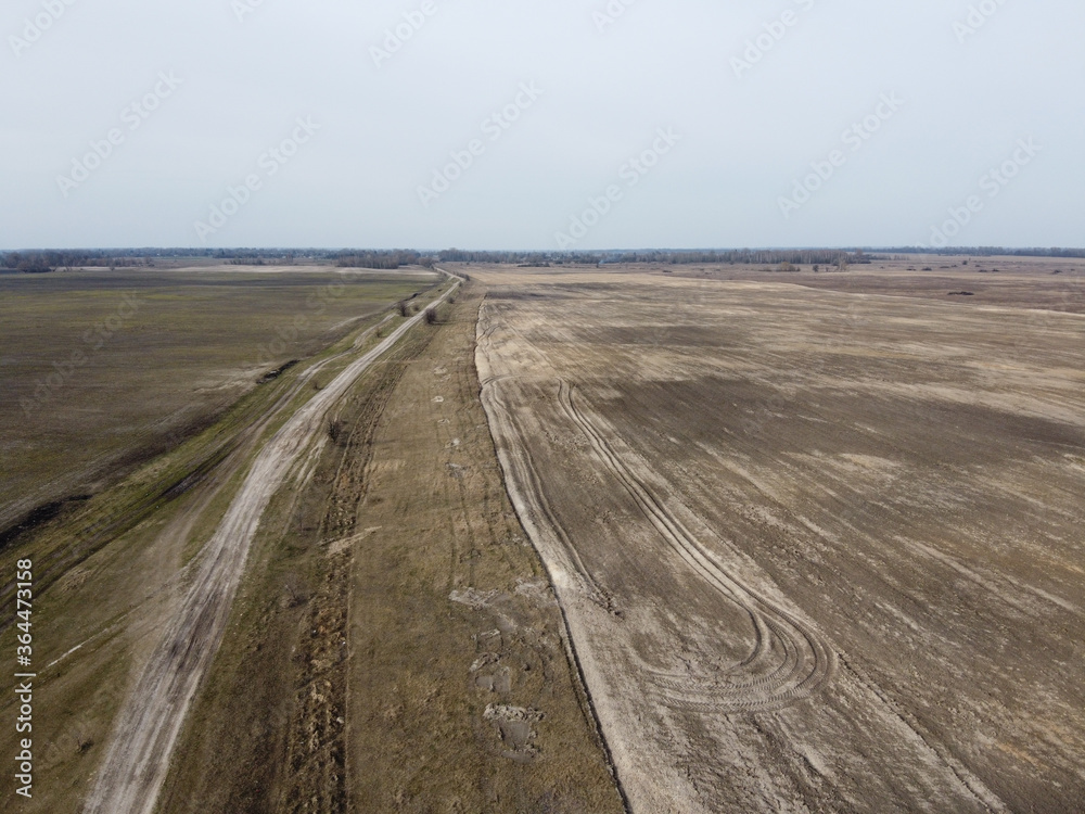Dirt road in the fields, aerial view. Landscape.