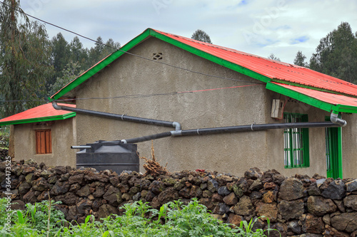 RWANDA: Model resettlement village to accommodate people from areas prone to floods and landslides. Houses have rainwater reservoirs, a biogas pit, and a home garden.  photo